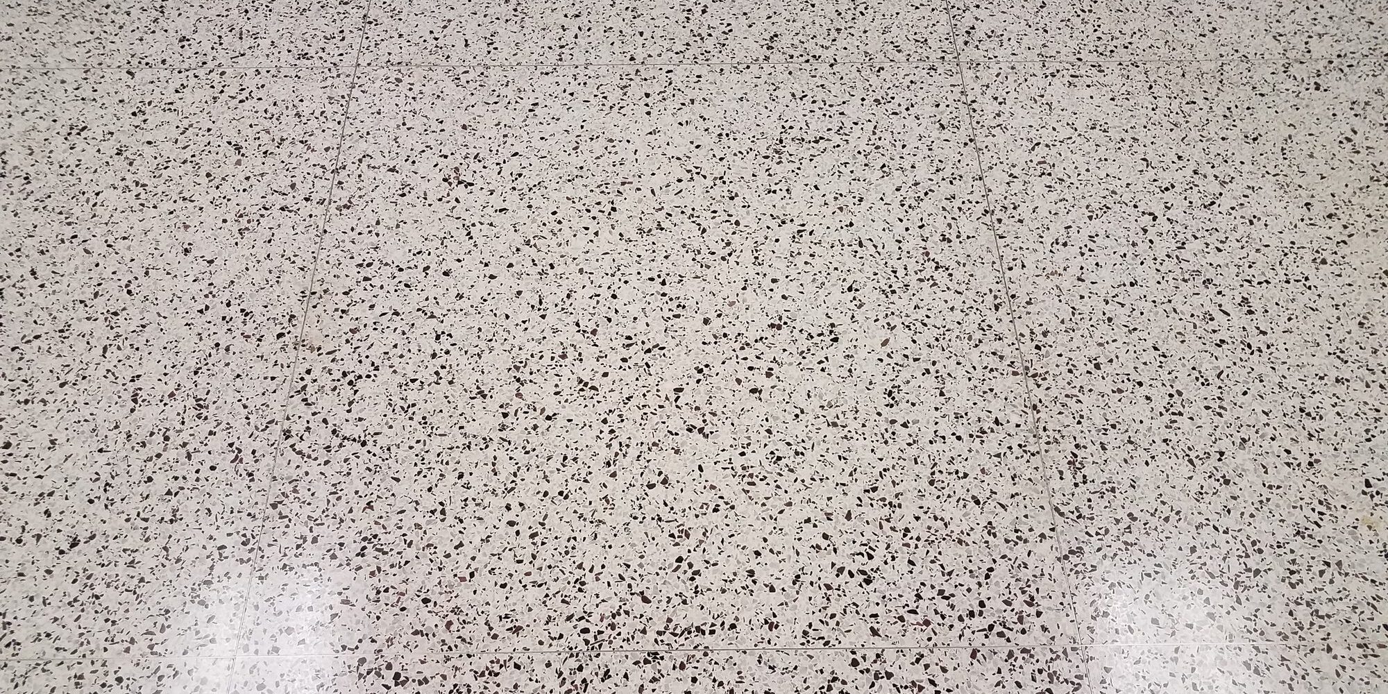 black and white floor tile on ground with reflection or glare