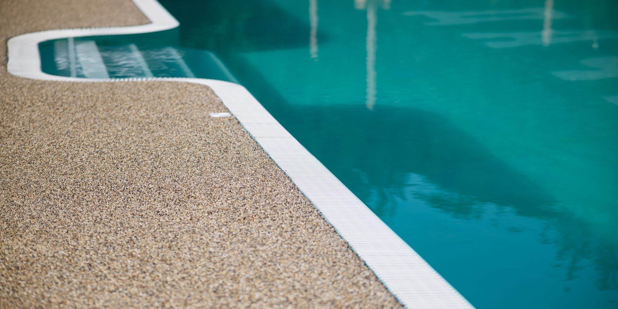 Clear clear water in the swimming pool. Stairs to the pool and side